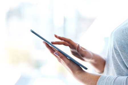 Business at the tap of an icon. Closeup shot of an unidentifiable businesswoman using a digital...