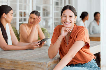 Smiling, happy and motivated female entrepreneur attending a meeting with a positive mindset in creative office. Portrait of confident and proud entrepreneur satisfied with job in a startup businessの写真素材