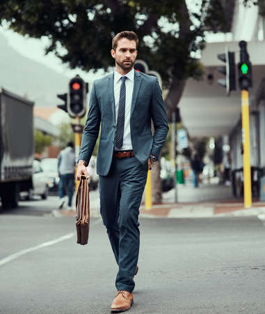 Man with a plan on the move. a handsome young businessman out in the city.の写真素材