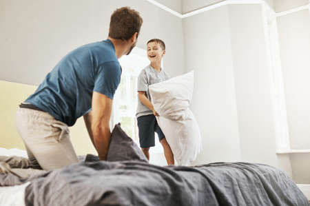 Making the most of a day indoors. a young boy and his father spending some quality time at home.