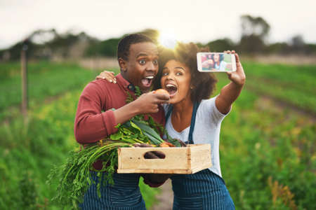 Yum yum. an affectionate young couple taking selfies while working on their farm.