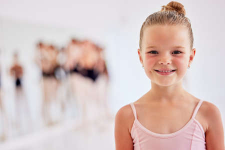 Little ballerina girl learning ballet dancing, art form and hobby in dance studio. Portrait of cute young child, smile dancer and happy kid excited for classical performance lesson, training and funの写真素材