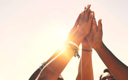Friends stick together. a group of unrecognizable people high-fiving.の写真素材