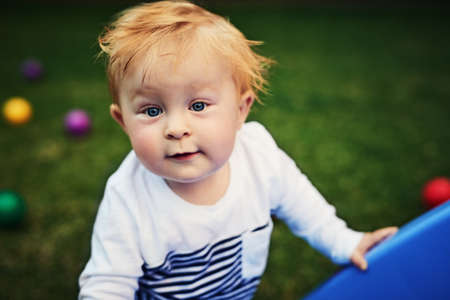 Little boys just want to have fun. an adorable little boy playing in the backyard.