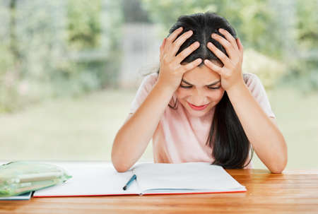 Stress, anxiety and overwhelmed with a little girl struggling with her studies, education and...