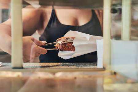 Do you like your lunch fresh. an unrecognizable woman holding freshly baked bread.の写真素材