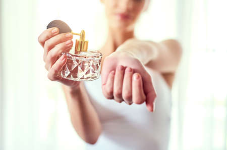 Tell me what you think... Closeup shot of an unrecognizable woman applying perfume to her wrists.