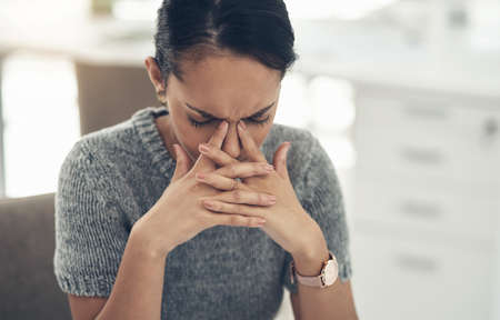 Work stress, bad anxiety and job worry of a stressed female office worker with a headache. Business...