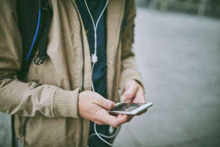 His favourite tunes are accompanying him on his commute. High angle shot of a unrecognizable man...