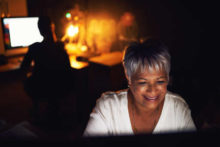 Making success happen right through the night. a mature businesswoman working late in an office.