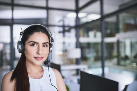 One has to keep calm when dealing with customers. Portrait of a cheerful businesswoman talking to a...