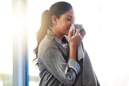 It smells so fresh and clean. a woman doing her daily chores at home.の写真素材