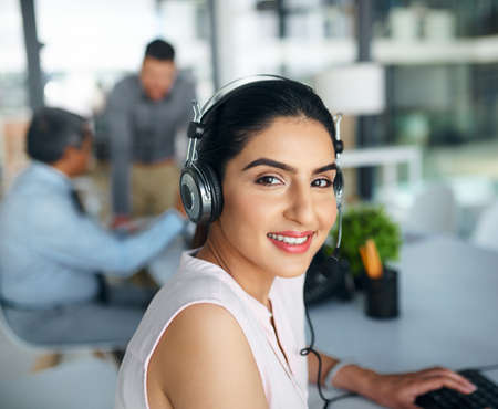 Were at your service whenever you need. Portrait of a young woman working in a call centre.