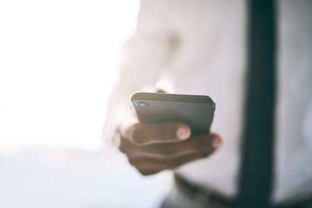 You can surf the net anywhere these days. a unrecognizable business person holding a cellphone and...