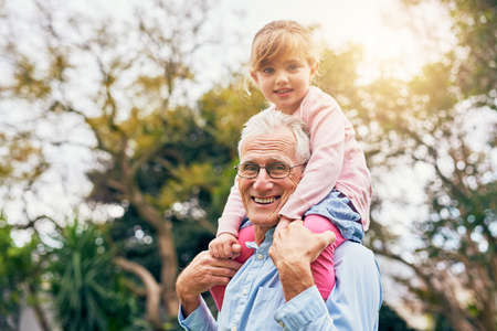 I love how tall Grandpa is. a grandfather bonding with his granddaughter.の写真素材