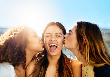 We love each other. young female friends spending the day outside.の写真素材