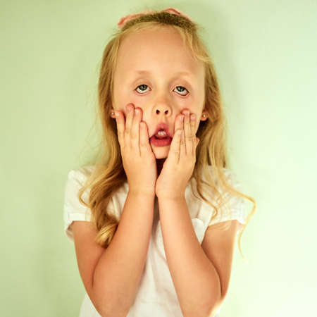 Im so bored right now. Portrait of a bored little girl holding her face with her hands while looking...