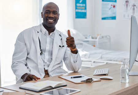 Doctor with thumbs up, success and trust hand sign or emoji for good healthcare, medical breakthrough or positive results. Happy portrait of health professional with like, thank you or ok finger iconの写真素材