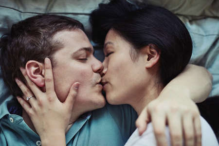 Your kisses take my breath away. a loving young couple relaxing at home.