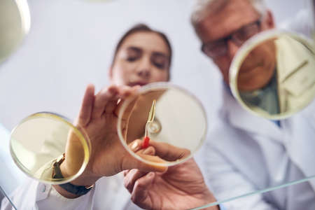 Closely observing the chemical reaction. Low angle shot of two scientists conducting an experiment...