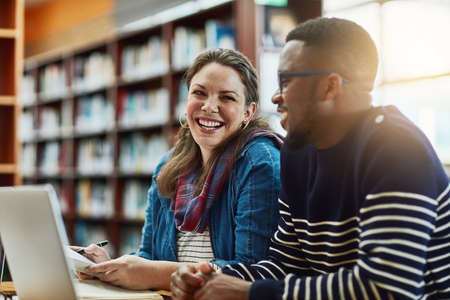Finals will be a breeze. two university students working together on a laptop at campus.