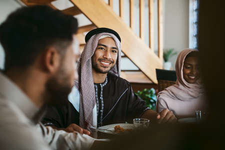 Muslim, arab and islamic man enjoying a meal for eid, ramadan or breaking fast with family while...