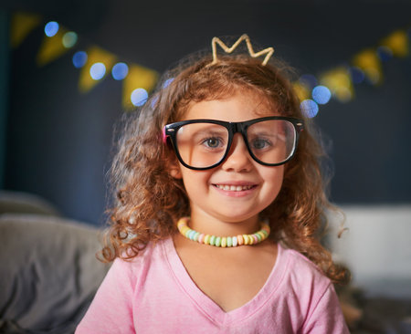 Shes a cutie. Portrait of an adorable little girl playing dress-up at home.の写真素材