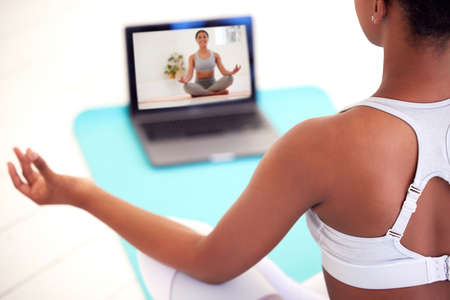 Streaming on laptop for yoga, meditation and zen tutorial, class and webinar in home lockdown or...