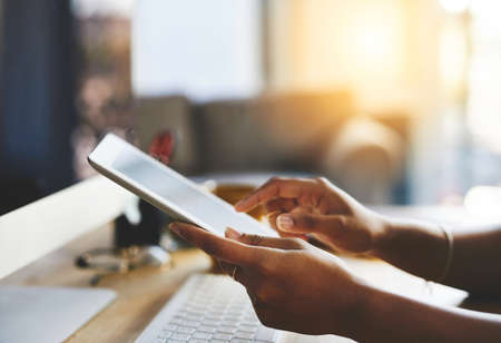 Stay connected. an unrecognizable businesswoman working on a digital tablet.