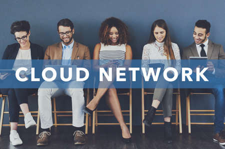 Connected on the cloud. Studio shot of businesspeople using wireless technology with the words cloud...