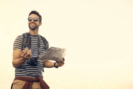 Go wherever the compass takes you. a young man enjoying a hike through the mountains.
