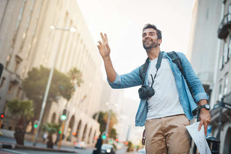 Off to the next destination. a young man taking photos while exploring a foreign city.の写真素材