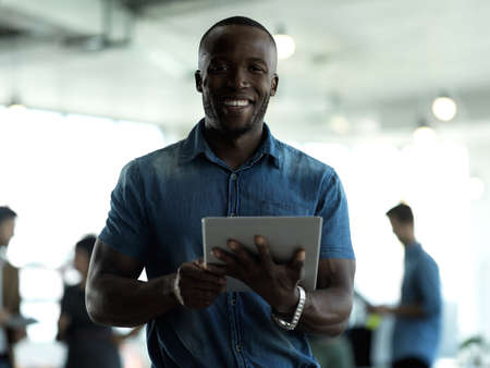 Everythings at the touch of a button. Cropped portrait of a handsome young businessman working on a...