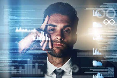 This code bores me. Cropped portrait of a young businessman looking bored coding late in the office.の写真素材