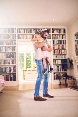 Dads got his hands and heart filled with love. a father hugging his little daughter at home.の写真素材