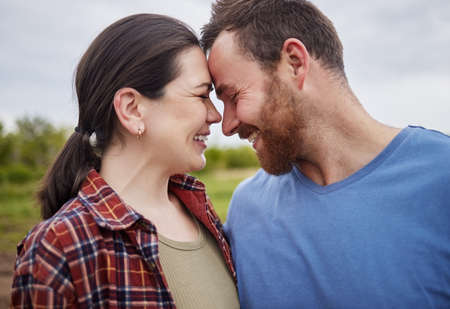 Happy mature couple bonding, laughing and having a romantic, intimate moment outdoors together....