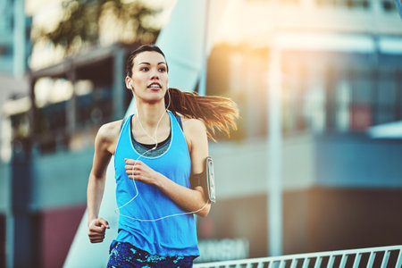 Dear maybe, were done. a young woman out in the city for her morning run.の写真素材