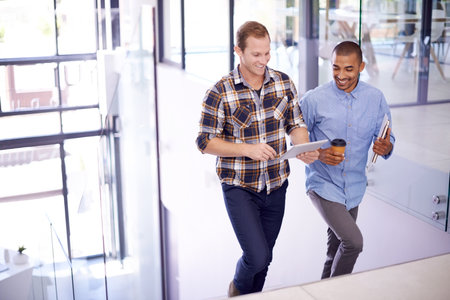 Its the perfect gadget to handle business on-the-go. two young designers working together on a...