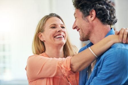 Her heart melts for him. a happy mature couple sharing an affectionate moment together at home.の写真素材