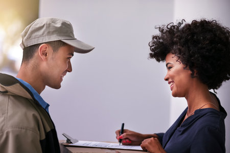 Logistics make the business world go round. a businesswoman signing for a package delivered by a...