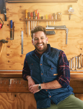 Ill build it in my workshop. Portrait of a handsome young handyman standing in his workshop.