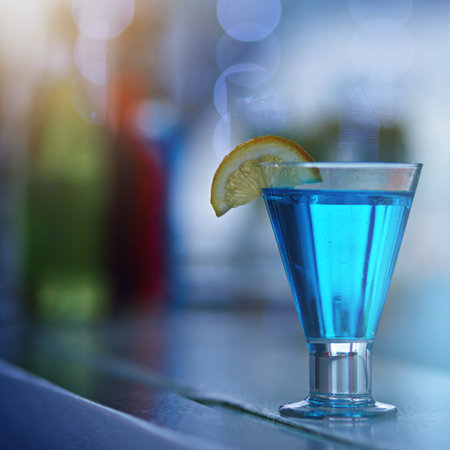 Its your party companion. a glass of alcohol on a countertop in a nightclub.の写真素材