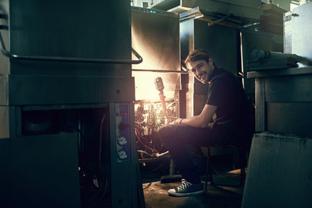 Somethings just needs a bit of tweaking. Cropped portrait of a handsome young man making some...