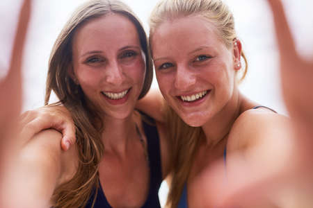Gotta get some snaps for the memories. Portrait of two young friends taking a selfie together...