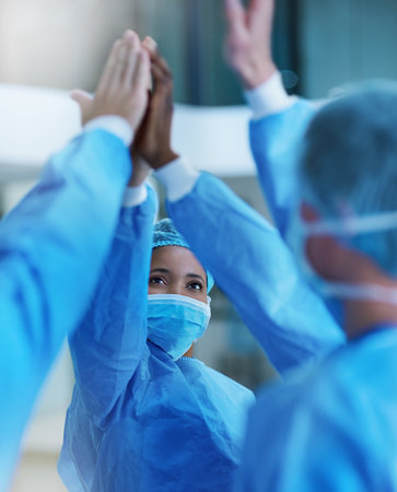 Wellness for the win. a team of surgeons giving each other a high five.