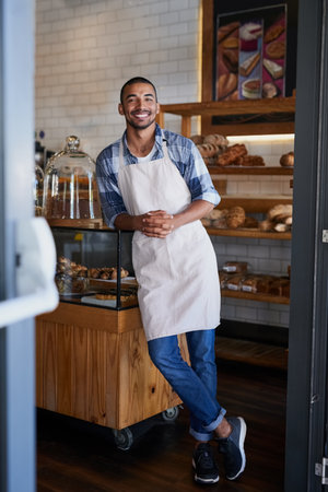 Searching for the best cafe Youre at the right place. Portrait of a young business owner standing in his bakery.の写真素材