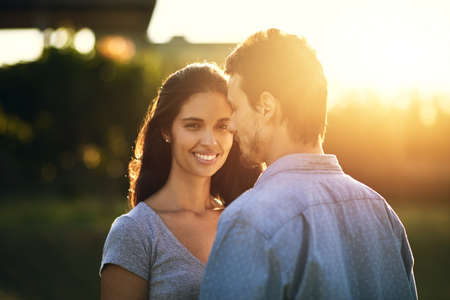 He makes me so unbelievably happy. Portrait of a young woman bonding with her boyfriend outdoors.の写真素材