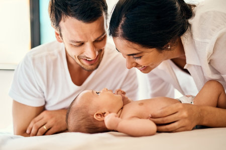 Born into a happy home. a happy mother and father bonding with their baby boy at home.
