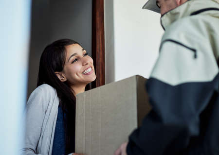 Thank you so much for the swift delivery. a young woman receiving her package from the courier.