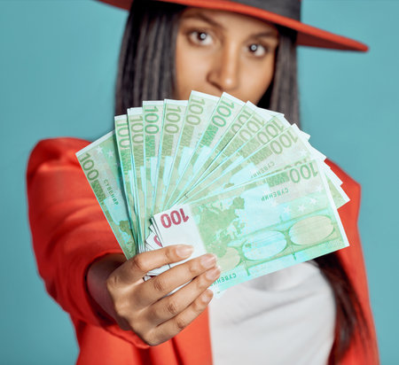 Rich, wealthy and stylish woman showing her money and success in fashion posing over copy space....